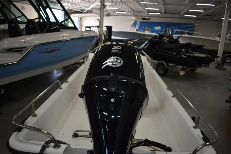 Slide: The Image of 2011 Carolina Skiff J16 boat with 30 HP engine in showroom. - 17