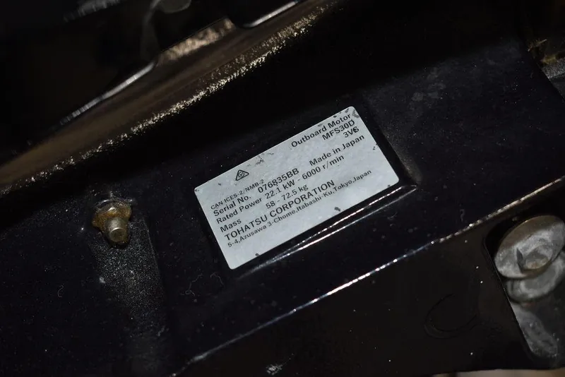 Slide: The Image of Label on Tohatsu outboard motor, model MFS9.8B, attached to 2011 Carolina Skiff J16. - 18