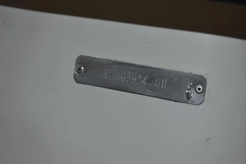 Slide: The Image of 2011 Carolina Skiff J16 hull identification number plate on white surface. - 20