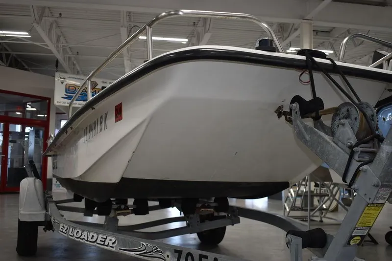Slide: The Image of 2011 Carolina Skiff J16 boat on trailer in indoor showroom. - 21