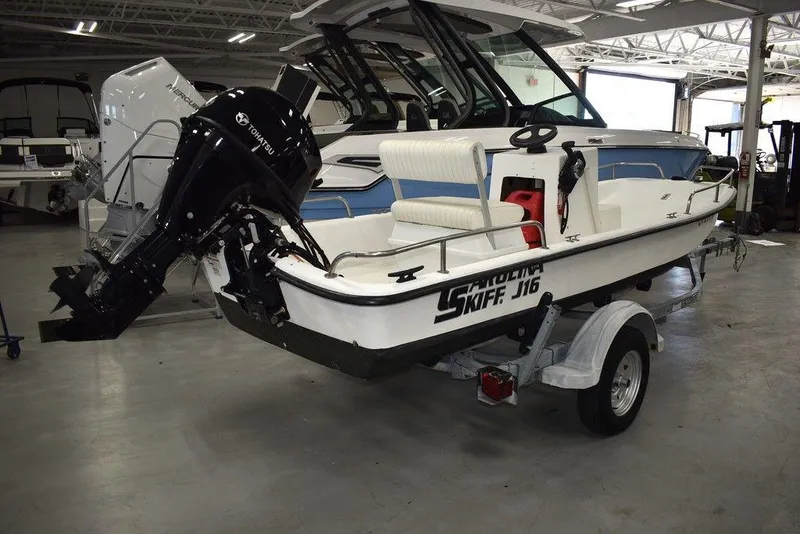 Slide: The Image of 2011 Carolina Skiff J16 boat on trailer in indoor showroom. - 3