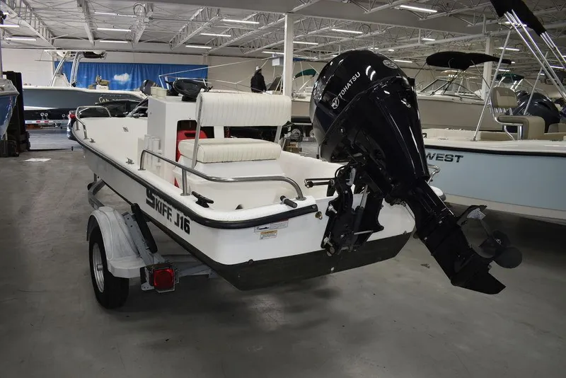 Slide: The Image of 2011 Carolina Skiff J16 boat with outboard motor on trailer in showroom. - 4