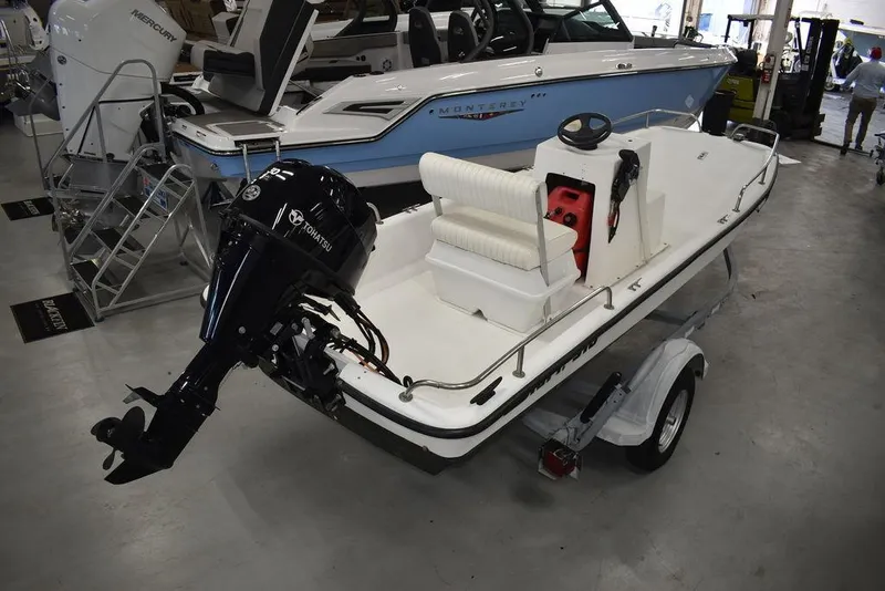 Slide: The Image of 2011 Carolina Skiff J16 boat with outboard motor on trailer in showroom. - 9