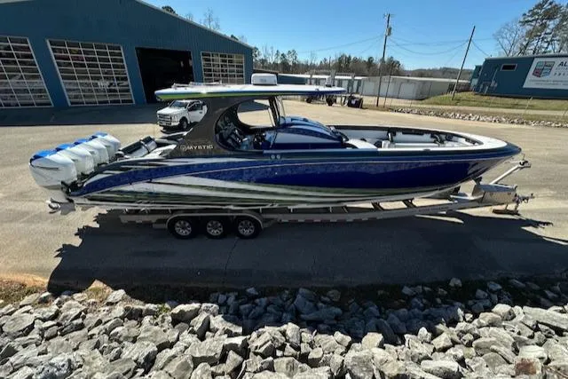 The Image of 2019 Mystic Powerboats M4200, blue and white, on trailer outside a garage. - 0