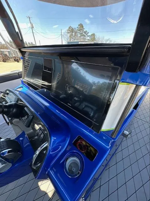 Slide: The Image of 2019 Mystic Powerboats M4200 dashboard with sleek blue design and advanced controls. - 11