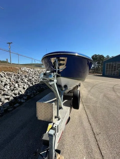 Slide: The Image of 2019 Mystic Powerboats M4200 on trailer, parked outdoors under clear blue sky. - 2