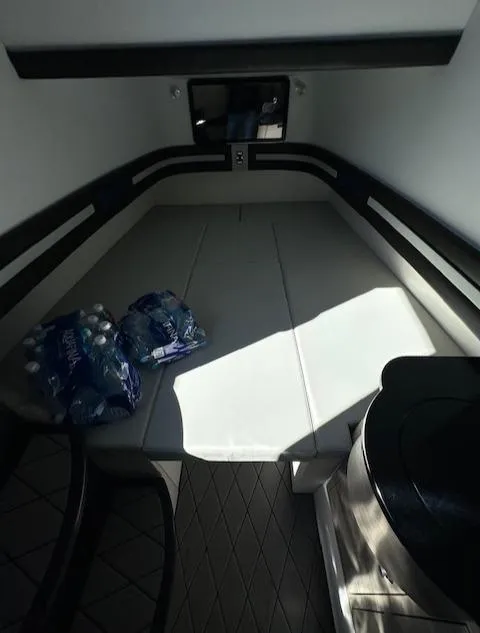 Slide: The Image of 2019 Mystic Powerboats M4200 cabin interior with seating and bottled water. - 23