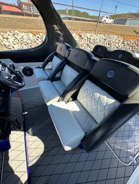 Slide: The Image of Interior seating of 2019 Mystic Powerboats M4200 with luxurious black and white design. - 26