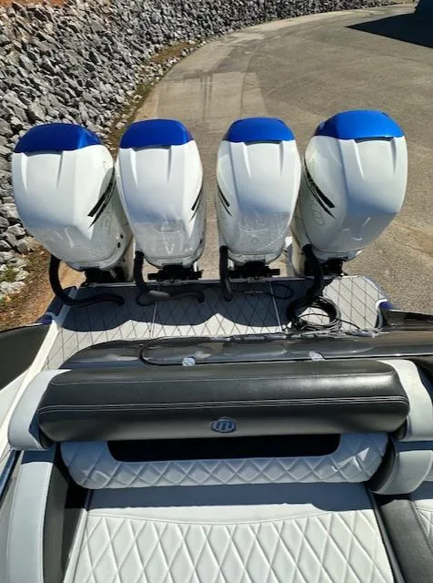 Slide: The Image of 2019 Mystic Powerboats M4200 with four powerful outboard engines, docked on a sunny day. - 29