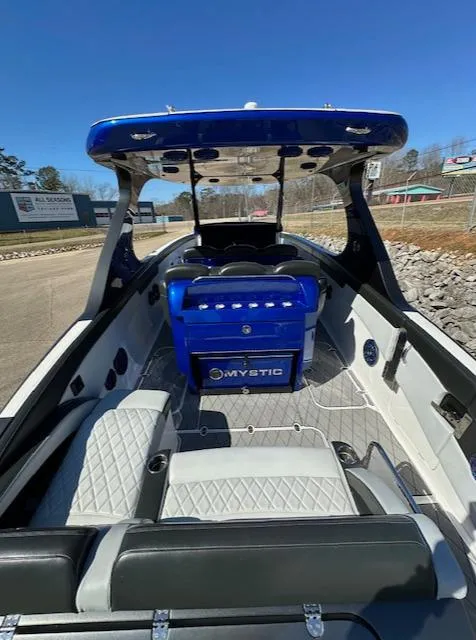 Slide: The Image of 2019 Mystic Powerboats M4200 with blue accents and spacious seating on a sunny day. - 4