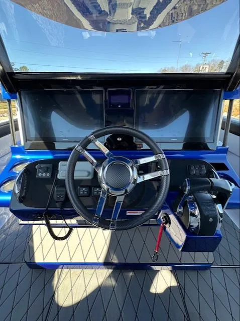 Slide: The Image of 2019 Mystic Powerboats M4200 helm with modern controls and sleek steering wheel. - 8