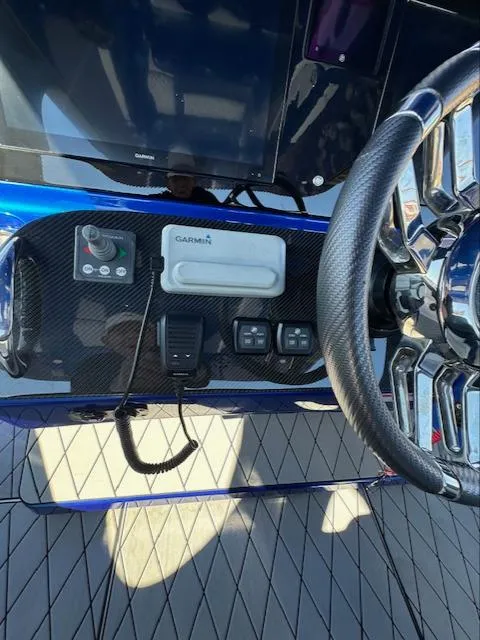 Slide: The Image of 2019 Mystic Powerboats M4200 dashboard with Garmin navigation and steering wheel. - 9