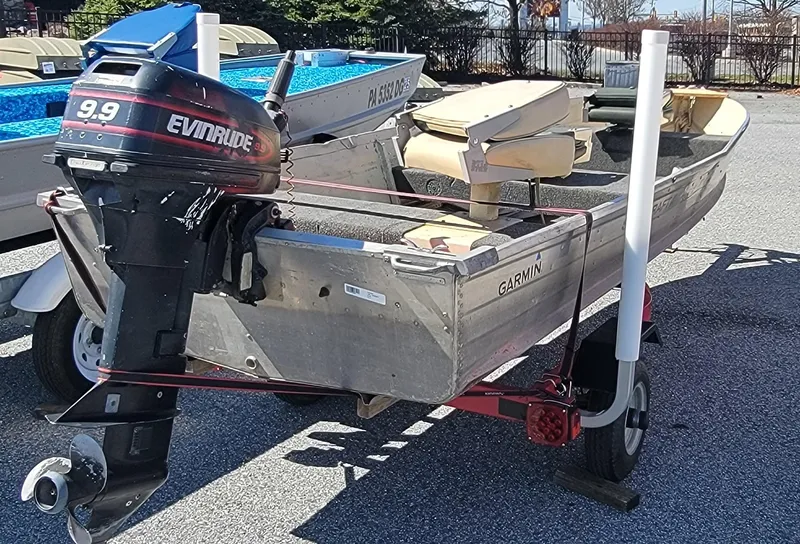 Slide: The Image of 1983 Starcraft SL-14 boat with Evinrude 9.9 motor on trailer. - 1