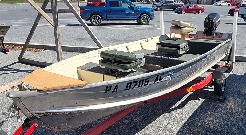 Slide: The Image of 1983 Starcraft SL-14 aluminum boat on trailer in parking lot. - 4
