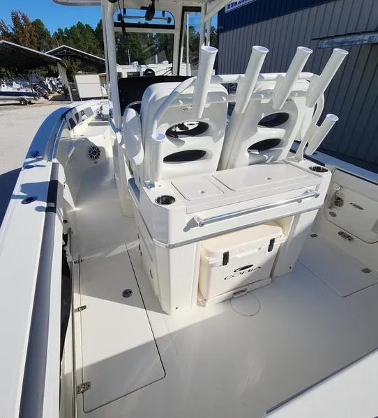 Slide: The Image of 2025 Cobia 265 Center Console boat with rod holders and storage compartments. - 11