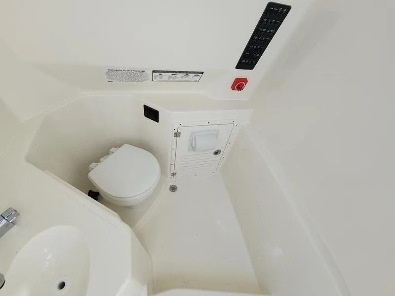 Slide: The Image of 2025 Cobia 265 Center Console boat interior with toilet and sink. - 21