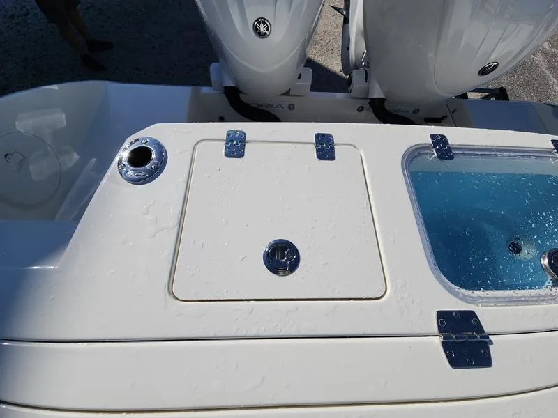 Slide: The Image of 2025 Cobia 265 Center Console boat deck with storage and livewell. - 25