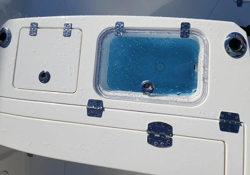 Slide: The Image of 2025 Cobia 265 Center Console boat with livewell and storage compartments. - 26