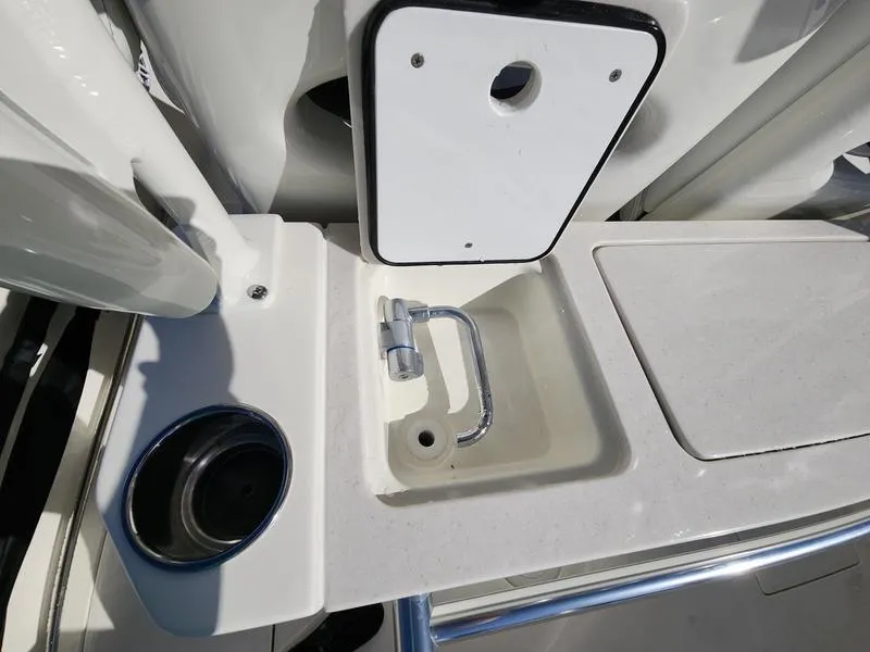 Slide: The Image of 2025 Cobia 265 Center Console boat sink and storage area detail. - 27