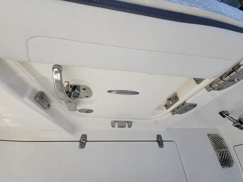 Slide: The Image of 2025 Cobia 265 Center Console boat hatch with stainless steel hardware. - 35