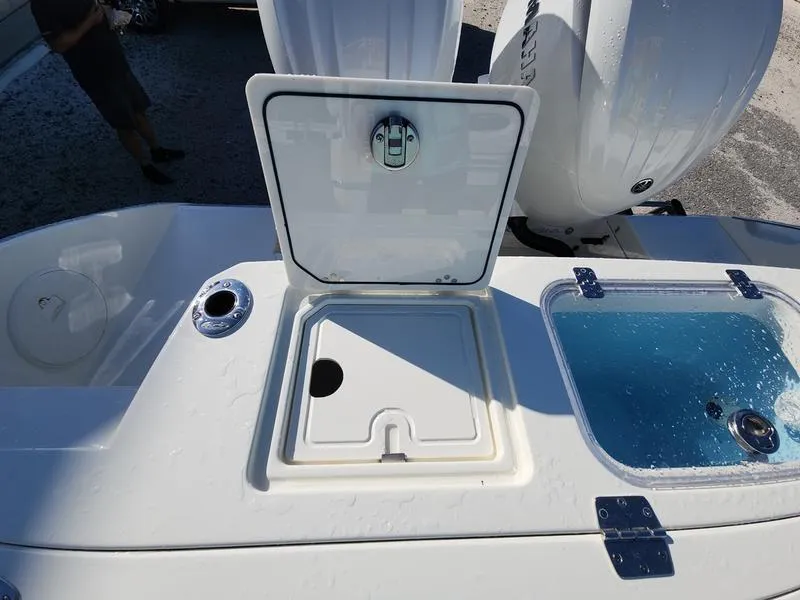 Slide: The Image of 2025 Cobia 265 Center Console boat with open storage compartment and livewell. - 38