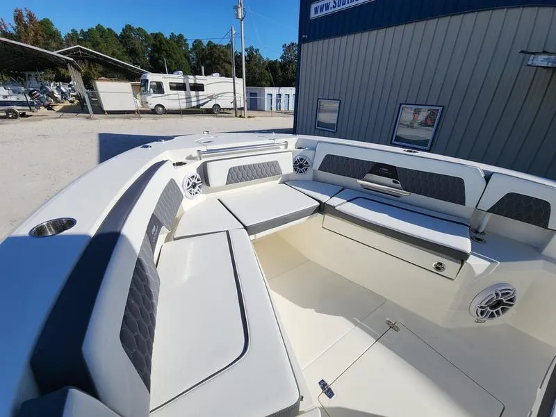 Slide: The Image of 2025 Cobia 265 Center Console boat interior with cushioned seating and speakers. - 41