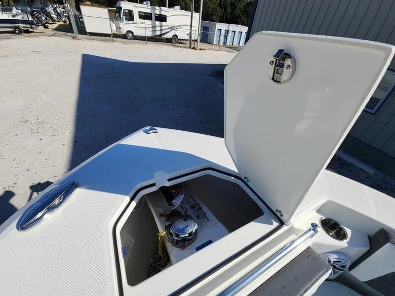 Slide: The Image of 2025 Cobia 265 Center Console boat with open storage compartment on deck. - 43