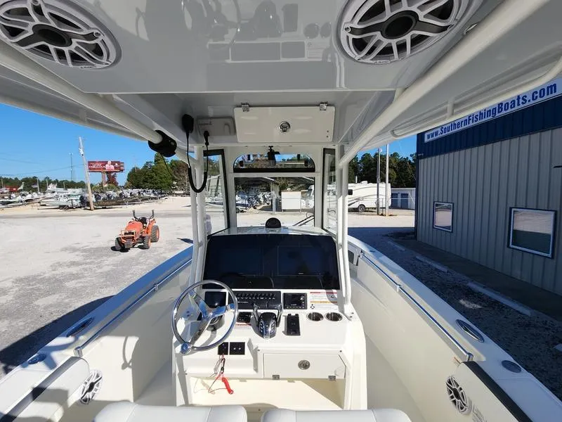 Slide: The Image of 2025 Cobia 265 Center Console boat interior with modern dashboard and steering wheel. - 6