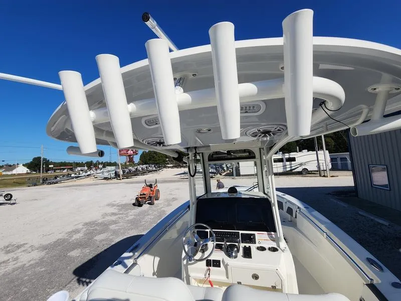 Slide: The Image of 2025 Cobia 265 Center Console boat with rod holders and modern dashboard. - 7