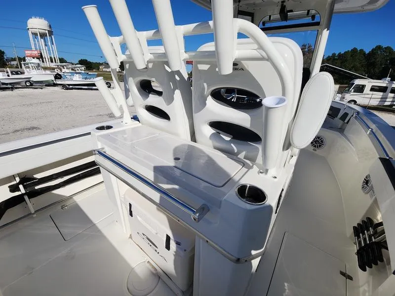 Slide: The Image of 2025 Cobia 265 Center Console boat with rod holders and storage compartments. - 9