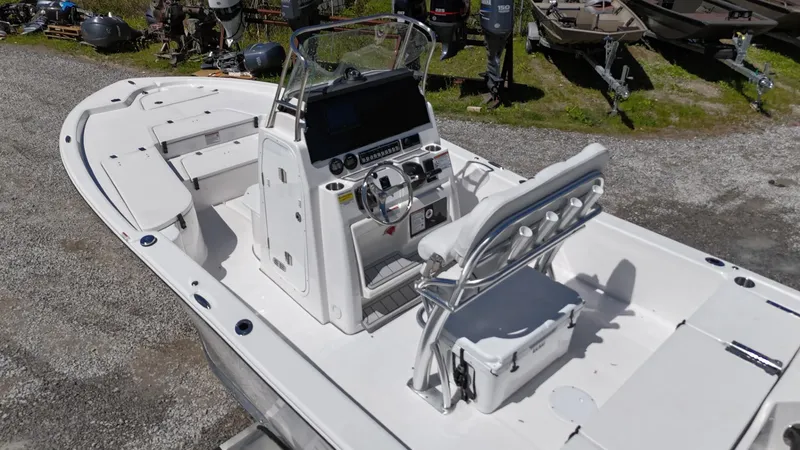 Slide: The Image of 2025 Sea Fox 231 Bay Fox boat with center console and seating, parked on gravel. - 16