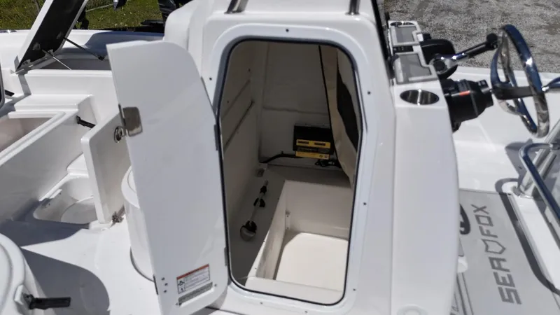 Slide: The Image of 2025 Sea Fox 231 Bay Fox boat interior with open storage compartment. - 18