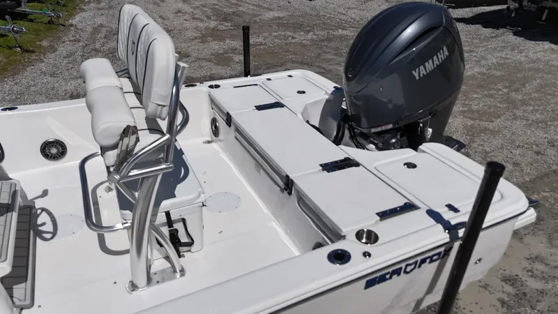 Slide: The Image of 2025 Sea Fox 231 Bay Fox boat with Yamaha engine, featuring white seating and storage compartments. - 21