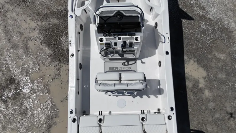 Slide: The Image of 2025 Sea Fox 231 Bay Fox boat interior, featuring console and seating, aerial view. - 22