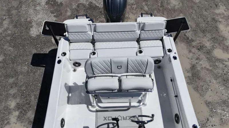 Slide: The Image of 2025 Sea Fox 231 Bay Fox boat interior with white seating and steering console. - 24