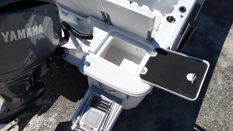 Slide: The Image of 2025 Sea Fox 231 Bay Fox boat with Yamaha engine, featuring storage compartments and ladder. - 27