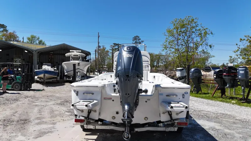 Slide: The Image of 2025 Sea Fox 231 Bay Fox boat with outboard motor in a marina setting. - 5