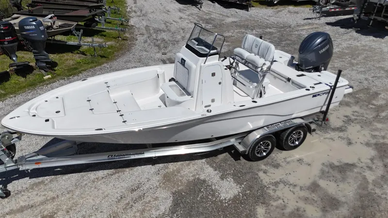 Slide: The Image of 2025 Sea Fox 231 Bay Fox boat on trailer, white exterior, parked outdoors. - 6