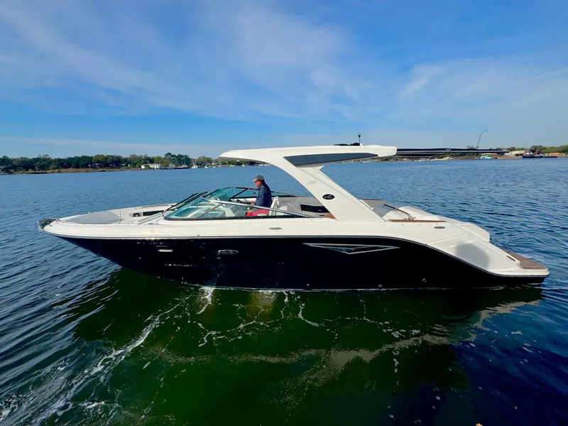 Slide: The Image of 2019 Sea Ray SLX 310 boat cruising on a sunny day. - 1