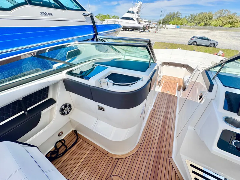 Slide: The Image of 2019 Sea Ray SLX 310 boat interior with sleek design and wooden flooring. - 17