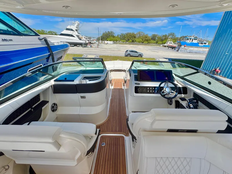 Slide: The Image of 2019 Sea Ray SLX 310 boat interior with luxurious seating and modern dashboard. - 18