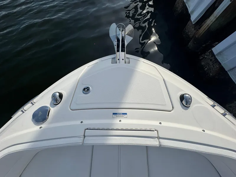 Slide: The Image of Bow of 2019 Sea Ray SLX 310 boat docked by water. - 29