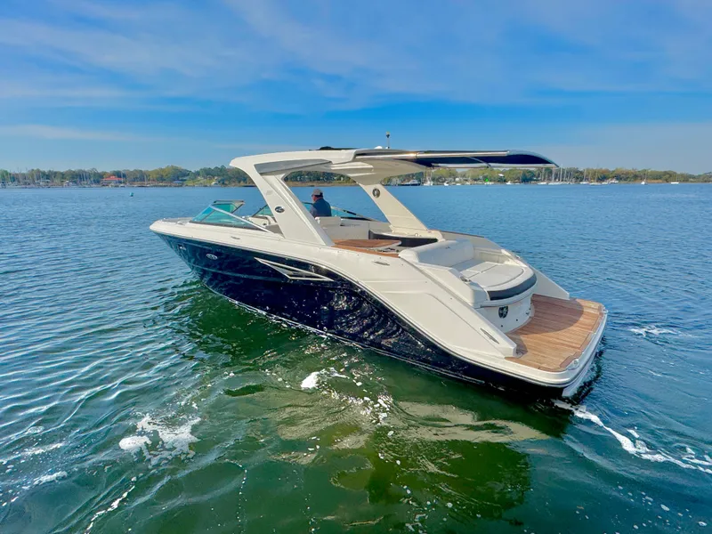 Slide: The Image of 2019 Sea Ray SLX 310 boat cruising on a sunny lake. - 3