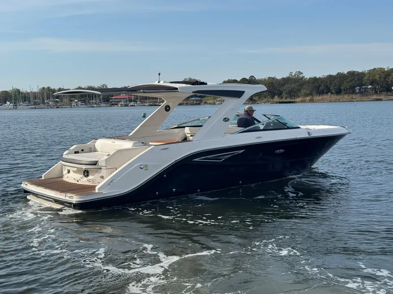 Slide: The Image of 2019 Sea Ray SLX 310 boat cruising on a calm lake. - 4