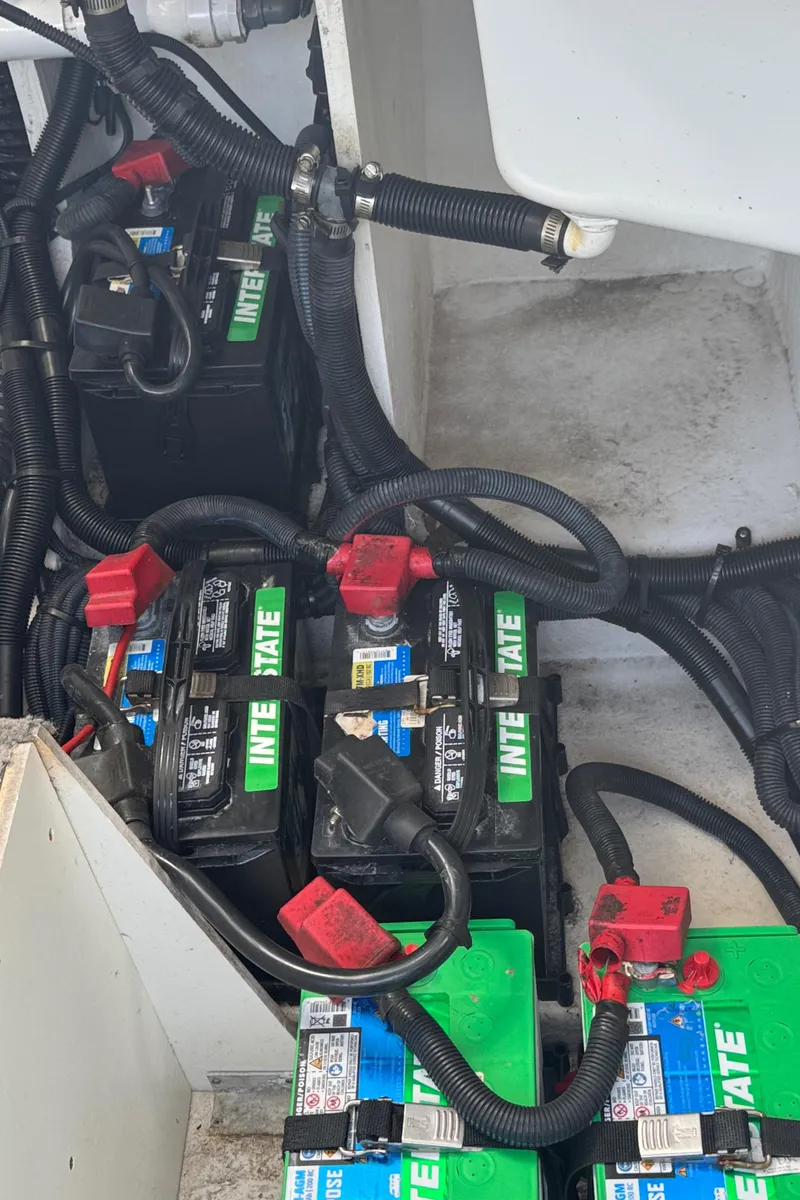 Slide: The Image of Batteries and wiring in a 2019 Sea Ray SLX 310 boat compartment. - 42