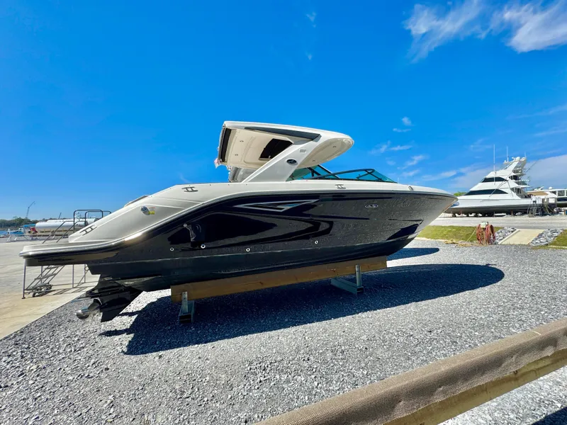 Slide: The Image of 2019 Sea Ray SLX 310 boat on display under clear blue sky. - 8