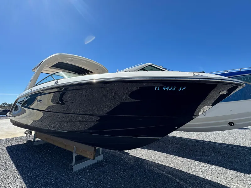 Slide: The Image of 2019 Sea Ray SLX 310 boat on display under clear blue sky. - 9