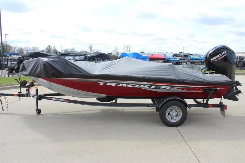 Slide: The Image of 2022 Tracker Pro Team 175 TXW boat on trailer, covered, parked outdoors. - 10