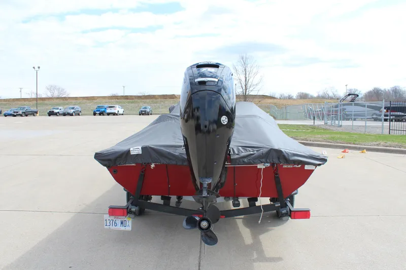 Slide: The Image of 2022 Tracker Pro Team 175 TXW boat with cover, parked on a concrete surface. - 11