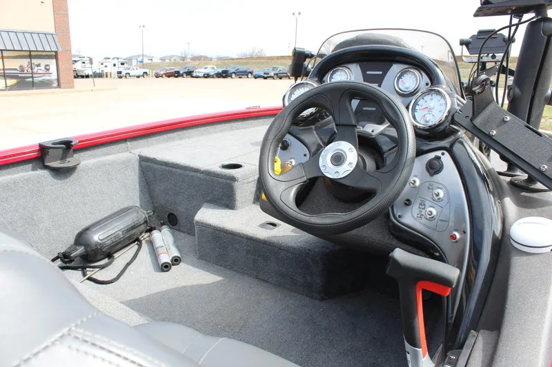 Slide: The Image of 2022 Tracker Pro Team 175 TXW boat interior with steering wheel and dashboard controls. - 14